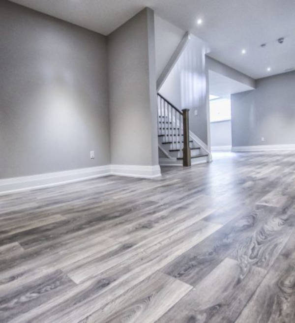 basement remodel with grey vinyl flooring