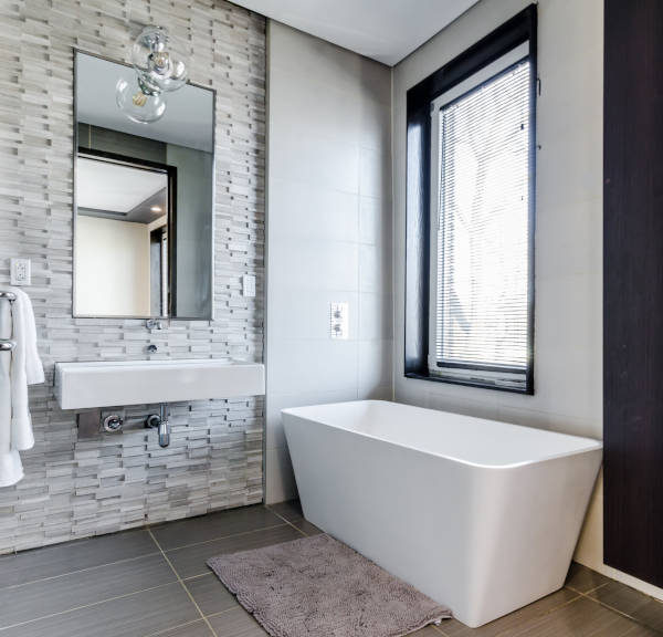 bathroom remodel with deep white tube and floating sink