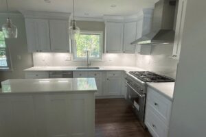 Remodeled Fairfield, NJ kitchen with white shaker cabinets, quartz counters and an island