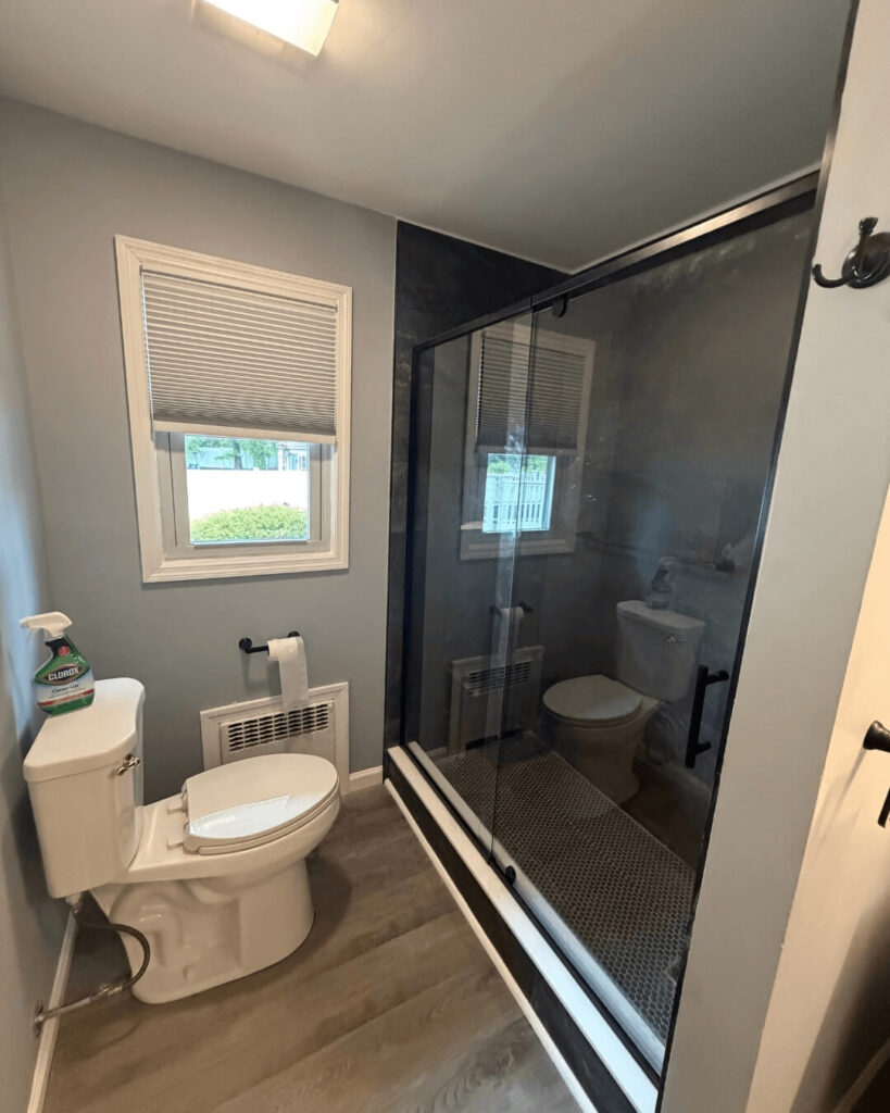 Finished Piscataway, NJ basement bathroom with walk-in shower and LVP floor